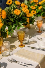 Vertical shot of sunflower decorations and dinnerware on a table