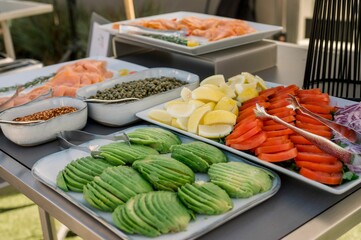 Closeup shot of sliced avocados, tomatoes, and lemons on a table