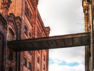 Old industrial overpass between ruined factory buildings