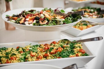 Appetizer buffet with green salads and couscous