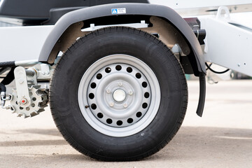 Obraz na płótnie Canvas Industrial lift new fresh trailer tire from side