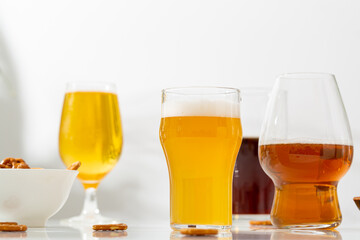 Several Glass set with light beer dark on light background