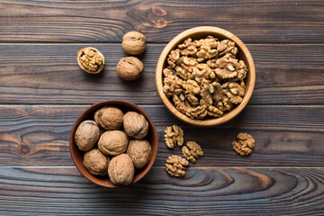 Fresh healthy walnuts in bowl on colored table background. Top view Healthy eating bertholletia concept. Super foods