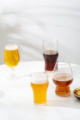 Several Glass with light beer dark empty on light background