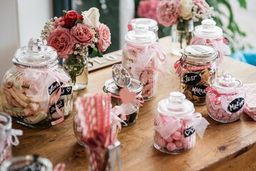 Closeup of the wedding decorations in glass jars on the table, blurred background