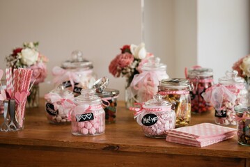 Closeup of the wedding decorations in glass jars on the table, blurred background