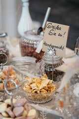 Vertical closeup of flakes in jars with "grab it, handmade" inscription at a banquet