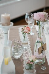 Selective focus of a decorated table with flowers in a vase ready for a wedding celebration