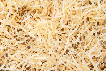 Wooden box with wood shavings straw chips fillings isolated on white.