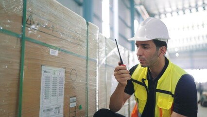 Professional caucasian elegant young engineer holding a radio communication talking with colleague...