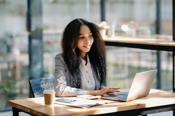 Obraz premium Business woman using tablet and laptop for doing math finance on an office desk, tax, report, accounting, statistics, and analytical research concept in office