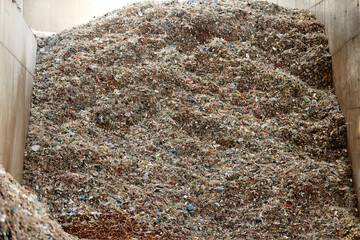 A pile of refuse-derived fuel (RDF) for combustion. Processing municipal solid waste to energy source. Energy resource recovery with waste-to-energy conversion. 