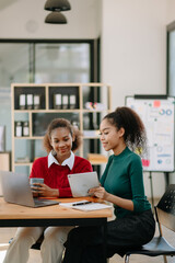 Fototapeta premium Business African woman leading team meeting and using tablet and laptop computer with financial in office