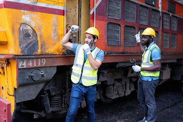 Railroad train maintenance engineer walkie talkie call giving signal to team during maintenance
