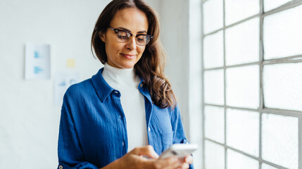 Woman using a phone to communicate with her business contacts