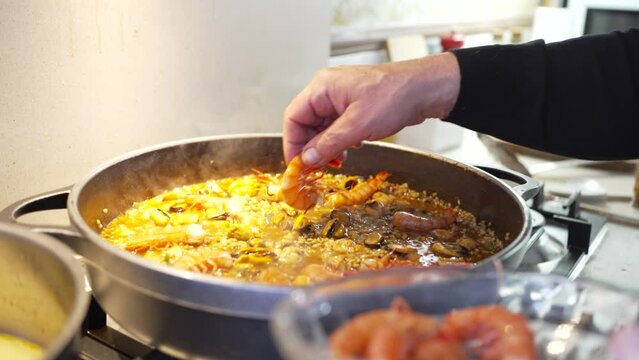 hand detail of prawns decorating the paella almost ended up in the kitchen, still steaming broth.