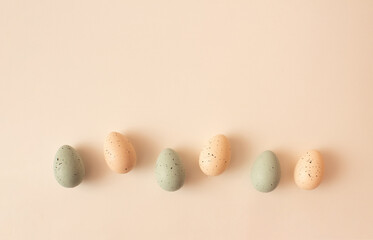 Composition with pastel Easter eggs on beige background. Flat lay. Pastel Easter creative composition.