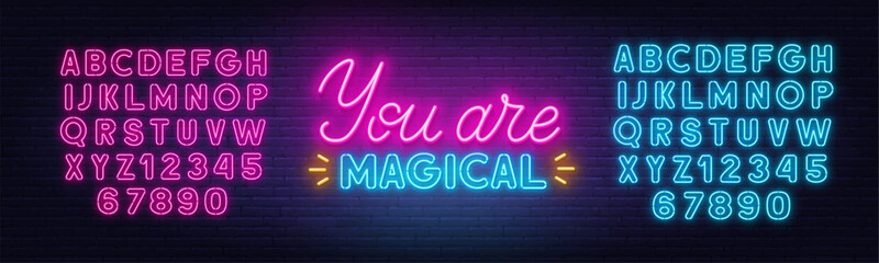 Naklejka na ściany i meble You Are Magical neon lettering on brick wall background.
