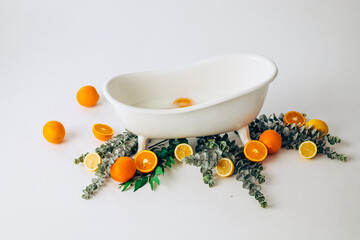 A white bathtub for bathing children, decorated with oranges and greens