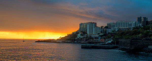 Fototapeta premium sunset in Sao Martinho lido coast walkway, Funchal on sunny winter day in february