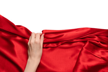 A woman's hand with red nails is trying to rip off a red silk fabric.