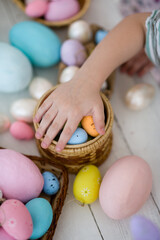 Fototapeta na wymiar Easter eggs children's hands put in a basket