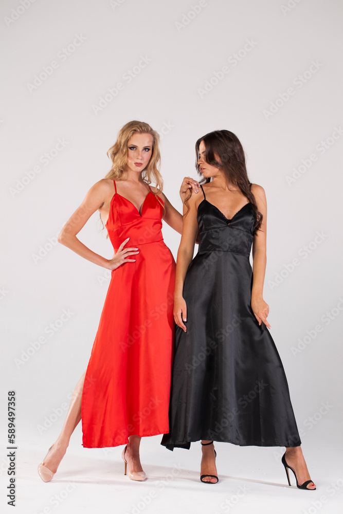 Poster Two sexy blonde and brunette models. Full length of a beautiful women in long dress