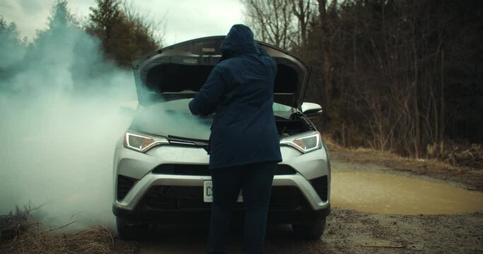 Worried Woman Opening Car Hood to Smoking Engine. Vehicle Breakdown Broken Motor Overheating Auto Failure. Frustrated Young Girl Stranded on Road Accident Emergency Repairs Trouble SoS Slow Motion 4k