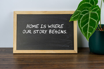 Inspirational quote text Home is where our story begins on mini chalk board