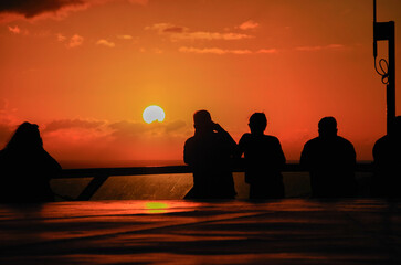 Beautiful dramatic sunset sunrise twilight blue hour seascape scenery over ocean with horizon and clouds cloudscape from cruiseship cruise ship liner sail away from Nassau, Bahamas