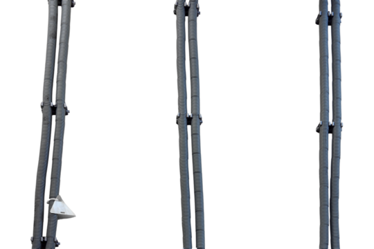 Wires on the wall in a protective round metal casing, isolated on a white background. Corrugated grey pipes for wire laying