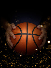 Basketball ball in male hands on black background with abstract lights