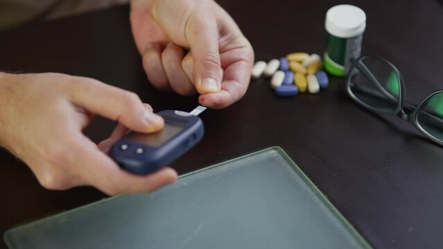 Patient diabetes measuring glucose level with glucometer