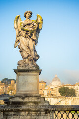 Fototapeta na wymiar Famous Bernini angel sculpture on San Angelo bridge in Rome, Italy
