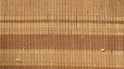 background texture, a rug of bamboo sticks, wooden sticks rewound with threads,