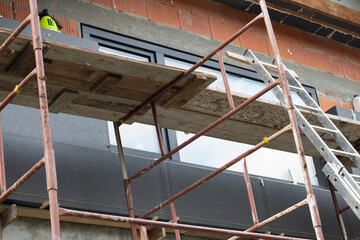 Scaffolding and insulation of the building with graphite polystyrene