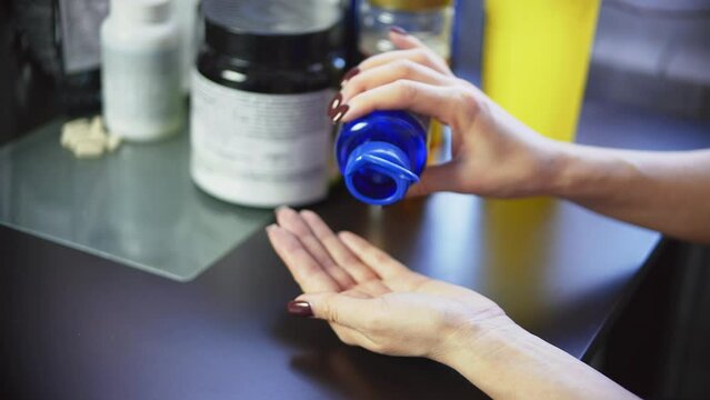 female taking dietary sport supplements