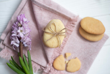 Easter cookies in the form of eggs and rabbits, flowers nearby