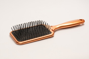A red hairbrush isolated on a white background. Hair tools.