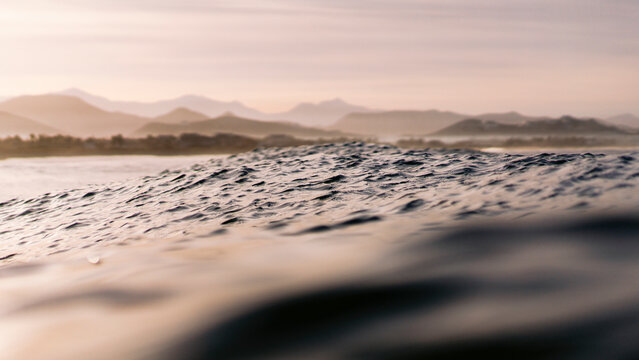 Fototapeta View of Wave surface texture in Pacific ocean with dreamy mountains landscape, Baja California Sur, Mexico.