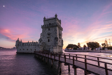 Beautiful view of the Belem Tower at sunset in the city center of Lisbon. High tide over the bank on the Tagus river side. Portugal
