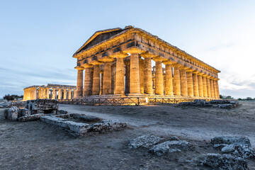 View of Second Temple of Hera and Poseidon temple in Paestum archeological site at sunset, Paestum, Salerno, Campania, Italy.