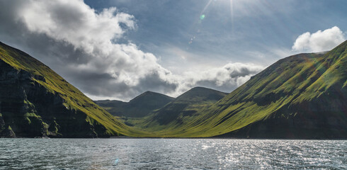 View of a sunlit Unalaska Island coastline, Unalaska, Alaska, United States.
