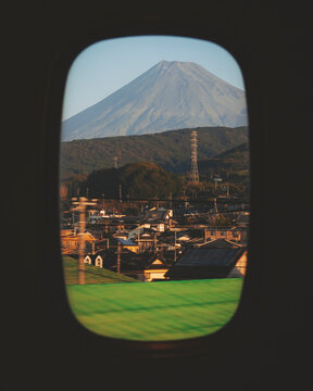 View of Mount Fuji from the window of a moving Shinkansen bullet train, Shizuoka, Japan.