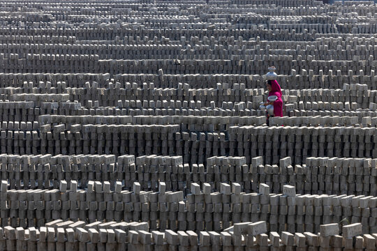 Keraniganj, Dhaka, Bangladesh - 7 November 2022: view of a woman working in the brick field.