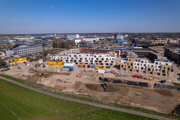 Meadow floodplains and aerial view on PUUR21 new housing construction project part of urban development in Zutphen with Noorderhaven neighbourhood along river IJssel
