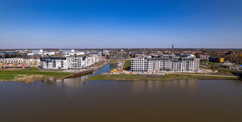Obraz premium Aerial wide panoramic view on recreational port and Kade Zuid construction site of the new Noorderhaven neighbourhood along the river IJssel in Zutphen, The Netherlands