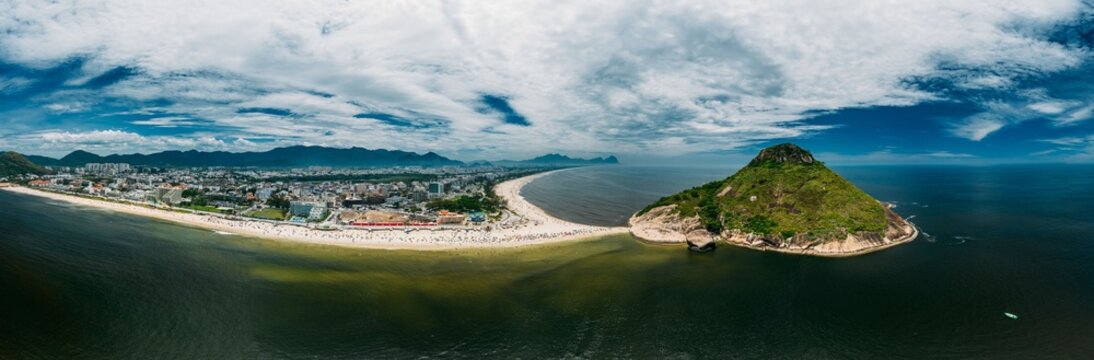 Aerial panoramic view of Pedra do Pontal, which divides Praia de Sernambetiba and Praia do Recreio, Rio de Janeiro, Brazil