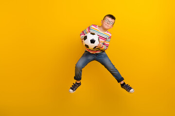 Full size photo of adorable kid boy playing soccer with team friends catch ball goal isolated on...