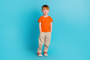 Fototapeta na wymiar Full length photo of positive little man hands pocket wear comfort stylish bright clothes empty space isolated on cyan color background